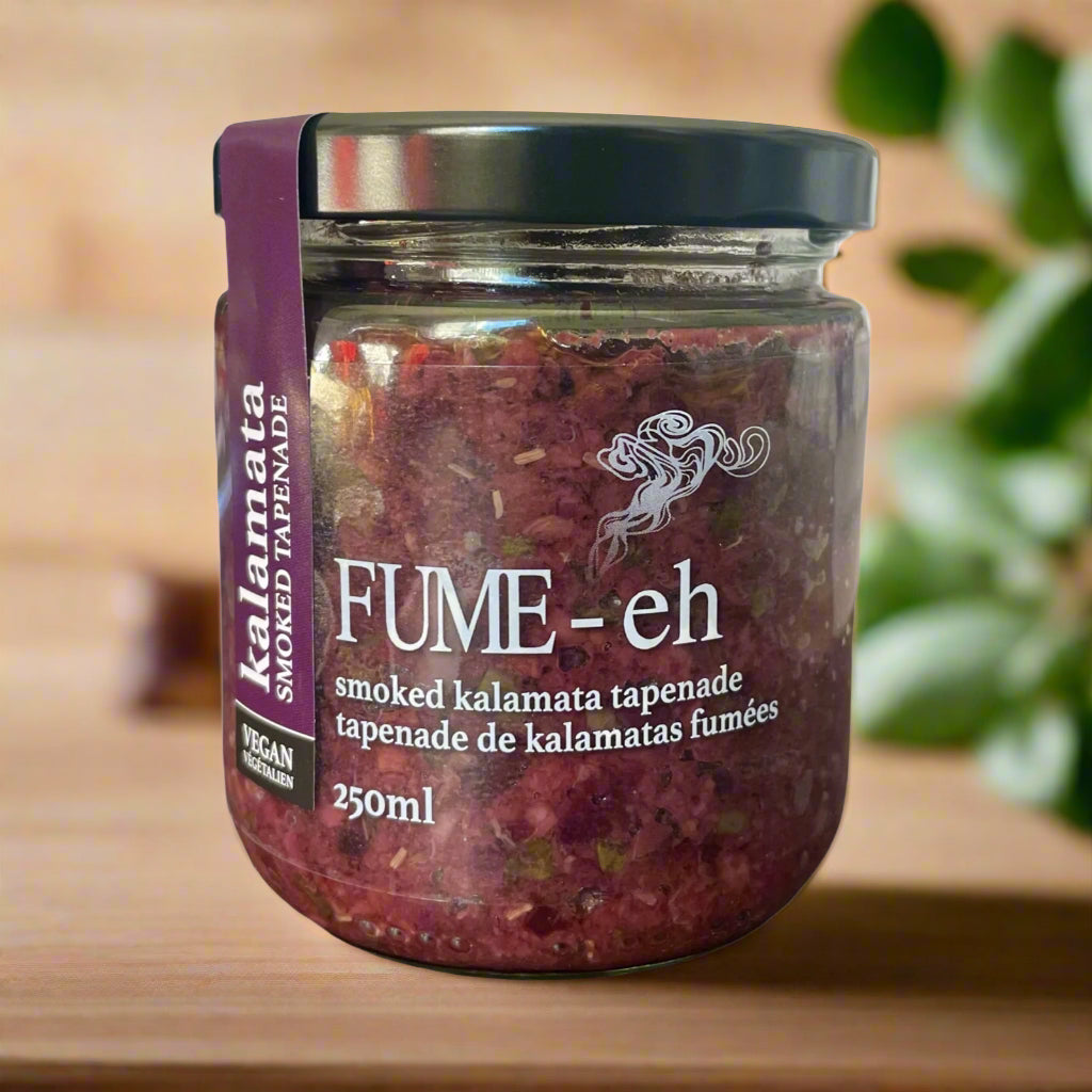 Jar of smoked kalamata tapenade, purple label, black lid, wooden background, 250ml.