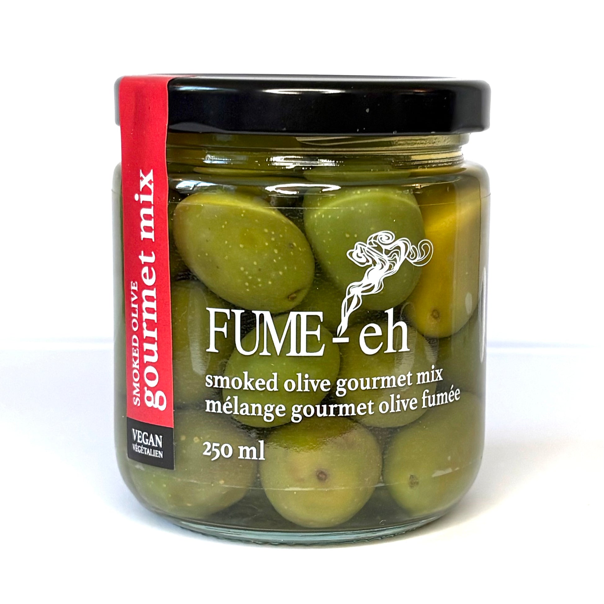 Jar of green olives with black lid and red label, text "FUME-eh" and "gourmet mix" visible.