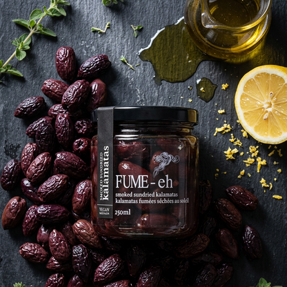 Jar of 'Fume-eh' surrounded by dried fruits, herbs, and a lemon on a dark surface